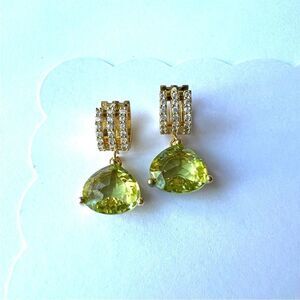 Green Peridot colored crystal earrings on gold huggie hoops.